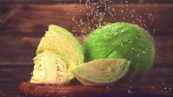 Super slow motion on the pieces of cabbage drop drops of water. Filmed on a high-speed camera at 1000 fps.On a wooden background. video