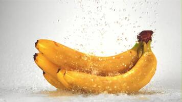 Super slow motion on bananas drop water droplets.Filmed on a high-speed camera at 1000 fps. On a white background. video