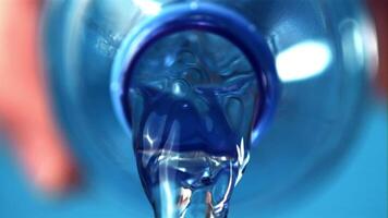 Super slow motion from the bottle pours pure water. On a blue background. Filmed on a high-speed camera at 1000 fps. video