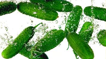 Super slow motion fresh cucumbers underwater with air bubbles. Filmed on a high-speed camera at 1000 fps.On a white background. High quality FullHD footage video