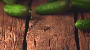 Super slow motion cucumbers roll on a wooden table. Filmed on a high-speed camera at 1000 fps. High quality FullHD footage video