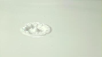Super slow motion drop in milk creates circles. Macro background. Filmed on a high-speed camera at 1000 fps.High quality FullHD footage video