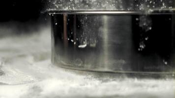 Super slow motion sieve falls on the flour. On a black background.Filmed on a high-speed camera at 1000 fps. video