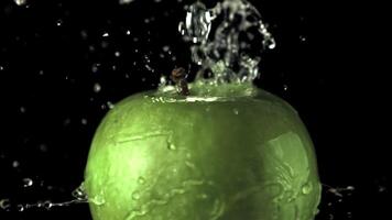 Super slow motion water drips on the rotating apple. On a black background. Filmed on a high-speed camera at 1000 fps.High quality FullHD footage video