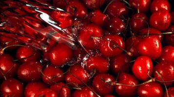 Super slow motion on the fresh cherry falls a jet of water. Macro background. Filmed on a high-speed camera at 1000 fps. video