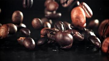 Coffee beans fall on the table. Filmed on a high-speed camera at 1000 fps. High quality FullHD footage video