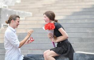 A couple is enjoying a summer vacation in the community area, happily showing their love to each other. photo