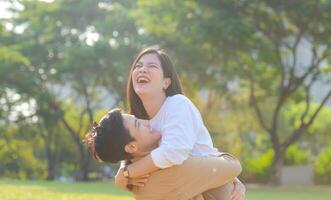 LGBT couple is enjoying a summer vacation in the park, happily showing their love to each other. photo