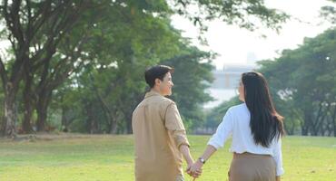 LGBT couple is enjoying a summer vacation in the park, happily showing their love to each other. photo