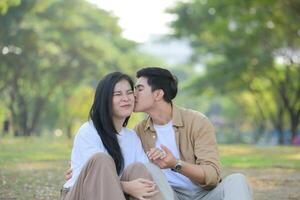 LGBT couple is enjoying a summer vacation in the park, happily showing their love to each other. photo