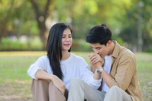 LGBT couple is enjoying a summer vacation in the park, happily showing their love to each other. photo