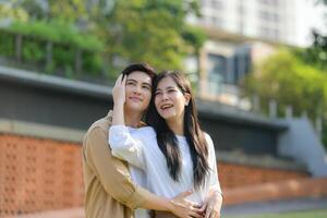 LGBT couple is enjoying a summer vacation in the park, happily showing their love to each other. photo