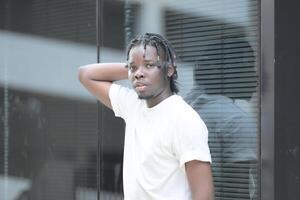 A young man with his hairstyle and the atmosphere of living in the community. photo