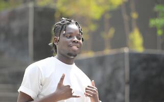 A young man with his hairstyle and the atmosphere of living in the community. photo