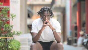 A young man with his hairstyle and the atmosphere of living in the community. photo