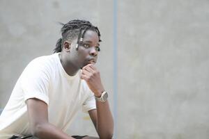 A young man with his hairstyle and the atmosphere of living in the community. photo