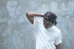 A young man with his hairstyle and the atmosphere of living in the community. photo