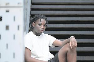 A young man with his hairstyle and the atmosphere of living in the community. photo