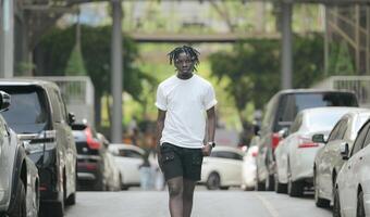 A young man with his hairstyle and the atmosphere of living in the community. photo