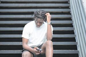 A young man with his hairstyle and the atmosphere of living in the community. photo