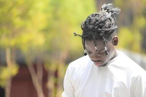 A young man with his hairstyle and the atmosphere of living in the community. photo