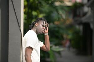 A young man with his hairstyle and the atmosphere of living in the community. photo