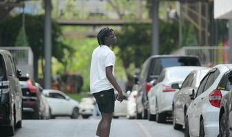 A young man with his hairstyle and the atmosphere of living in the community. photo