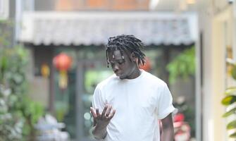 A young man with his hairstyle and the atmosphere of living in the community. photo