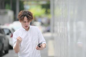 A young man with his hairstyle and the atmosphere of living in the community. photo