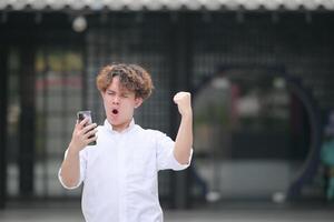 A young man with his hairstyle and the atmosphere of living in the community. photo