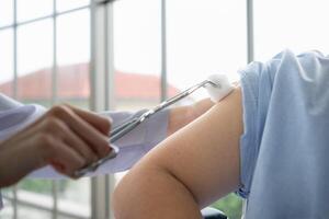 Doctor using syringe give the injection to the patient photo