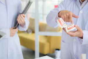 A medical professor is lecturing on a case study related to oral and dental treatment to medical students photo