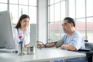 Doctor using a blood pressure monitor on a patient photo