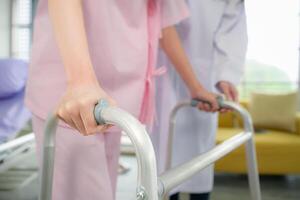 Following a period of treatment, the doctor examines the patient's legs and knees. photo