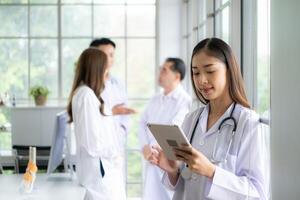 Portrait of female medical and team discuss a case study involving disease therapy for a hospital patient. photo