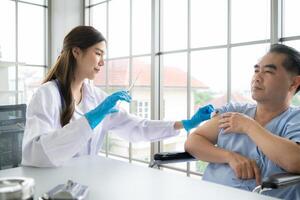 Doctor using syringe give the injection to the patient photo