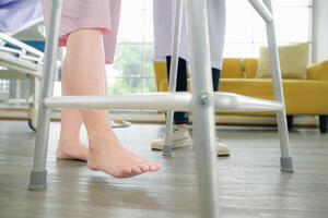 Following a period of treatment, the doctor examines the patient's legs and knees. photo