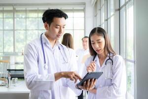 A team of medical discuss a case study involving disease therapy for a hospital patient. photo