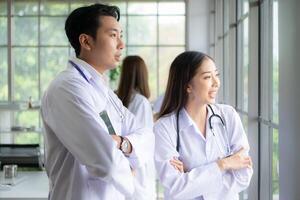 A team of medical discuss a case study involving disease therapy for a hospital patient. photo