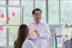 A medical professor is lecturing on a case study related to disease treatment to medical students photo