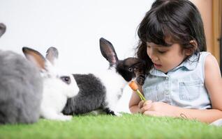 Easter bunny fun with little children the beauty of friendship between humans and animals photo