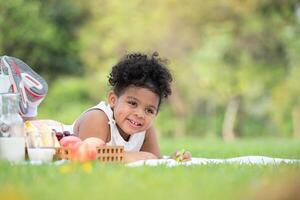 Happy family enjoying a picnic in the park, Girl are having fun drawing on paper photo