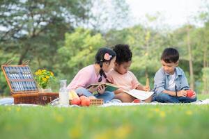 Happy family enjoying a picnic in the park, Children are having fun drawing on paper. photo