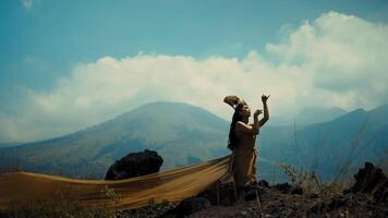 Hiker checking map on mountain trail with panoramic view of misty peaks and valleys. video