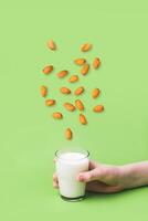 Children's hand holds glass of non diary milk. Health care, diet and nutrition concept photo