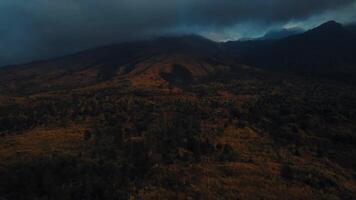 Moody landscape with dark clouds over autumn hills. video