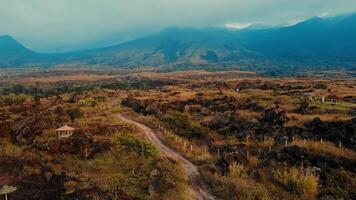 Scenic view of a winding trail through a rugged landscape with mountains in the background video