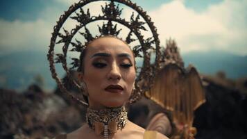 Woman in elaborate headdress and makeup, evoking cultural tradition, with soft focus background. video