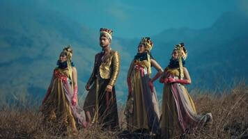 Group of women in traditional attire posing in a mountainous landscape. video