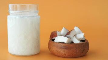 slice of fresh coconut and bottle of oil on a table video